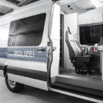 Polizeifahrzeug Typ Mercedes Sprinter mit geöffneter Schiebetür und Blick auf Arbeitsplatz im Innenraum