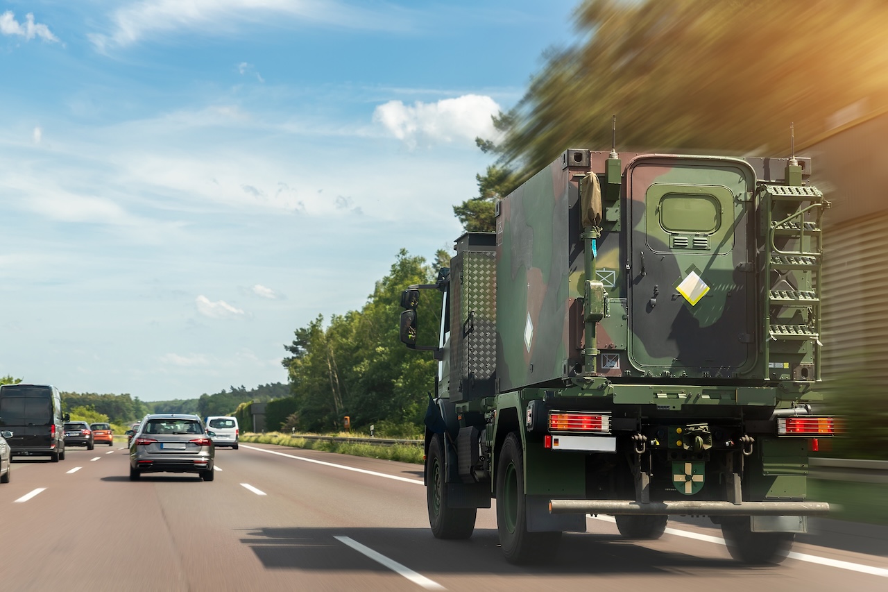 German armoured semi-trailer cargo truck carrier drive military convoy highway road. ALLIANCE troops moving reloceation rapid reaction force reinforcement eastern Europe. Sweden Finland fortification.